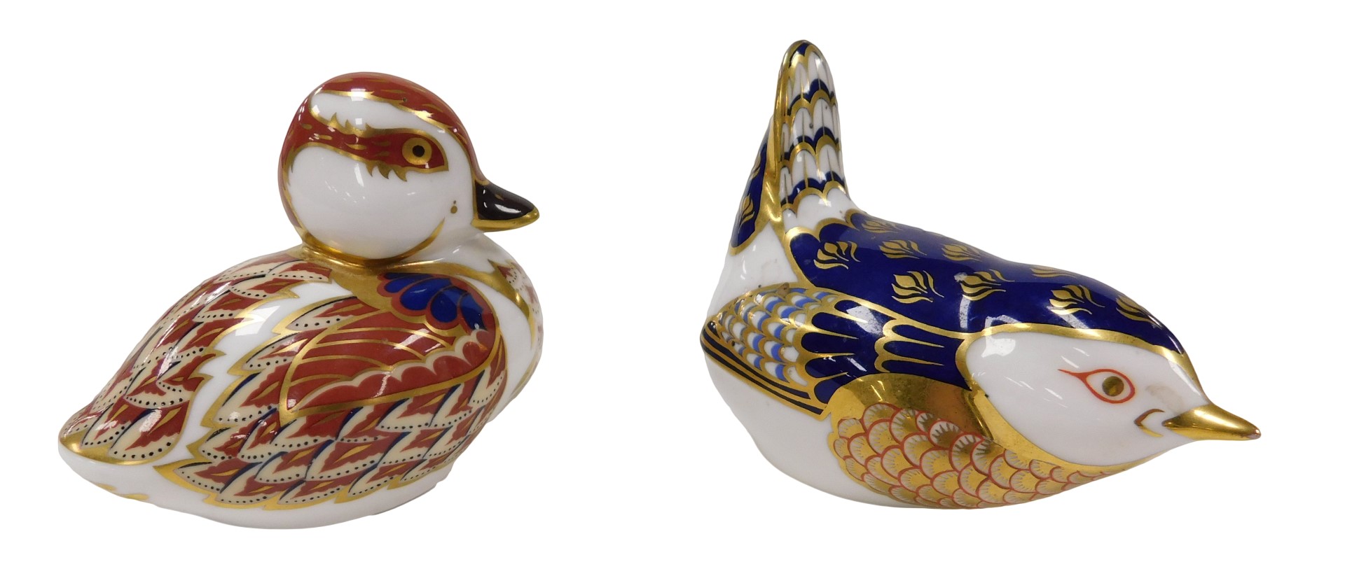 A Royal Crown Derby Imari paperweight, modelled as a swimming duckling, gold button and another mode