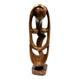 A modernist wooden carving of a fertility figure, on a square base, 76cm high.