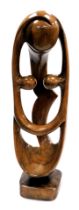 A modernist wooden carving of a fertility figure, on a square base, 76cm high.
