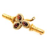 A Victorian Etruscan style red cabochon and diamond set bar brooch, of three leaf form, yellow metal
