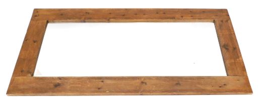 A rustic pine wall mirror, with a rectangular mirror plate, 91cm high, 181cm wide.