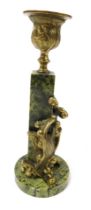An Art Nouveau green serpentine and brass candlestick, of urn form, raised on a square plinth, with