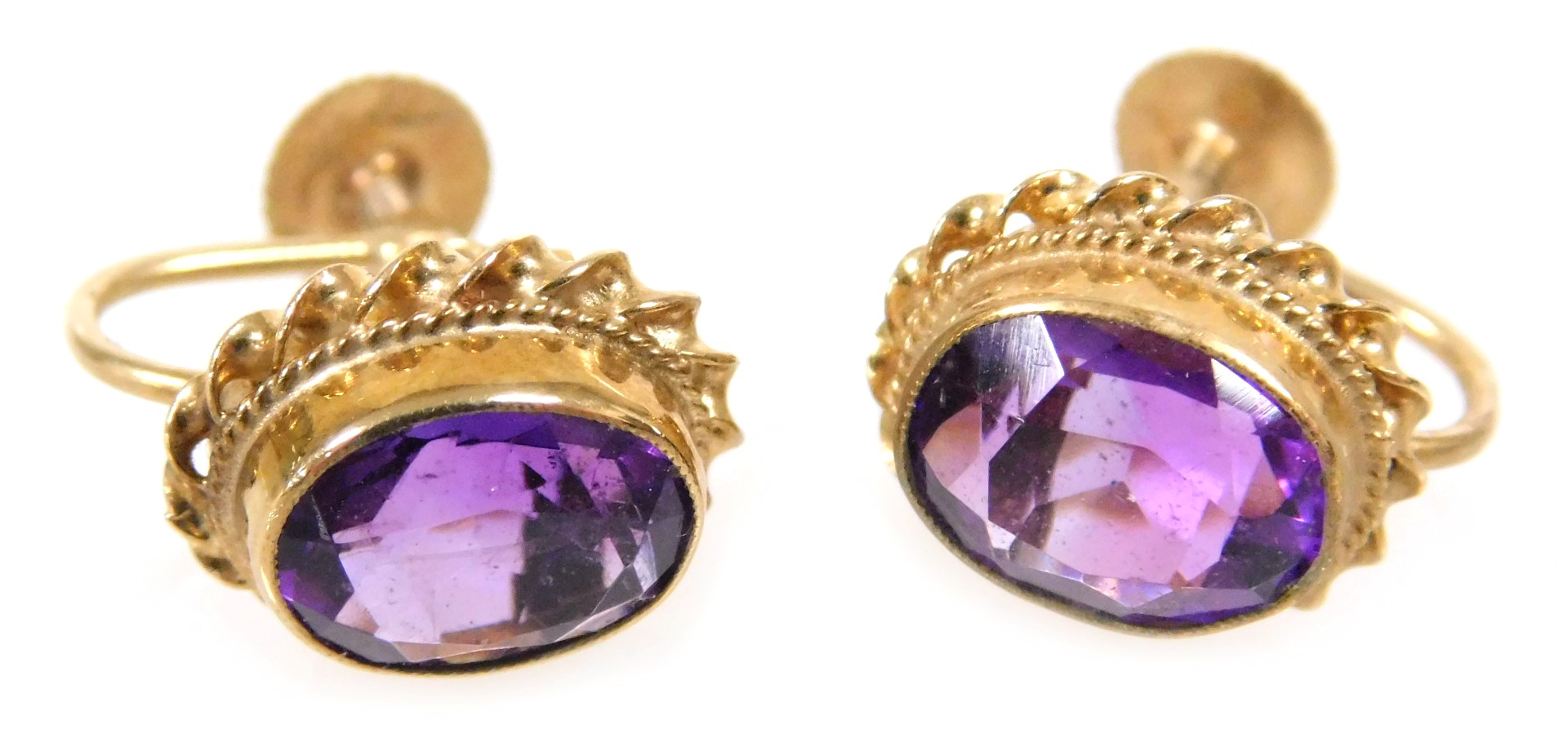 A pair of 9ct gold and amethyst earrings, with a screw fitting, the oval cut stones approximately 1.