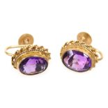 A pair of 9ct gold and amethyst earrings, with a screw fitting, the oval cut stones approximately 1.