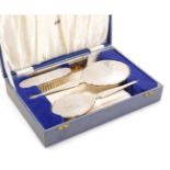 An Elizabeth II four piece silver backed dressing table set, with engine turned and engraved floral