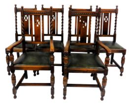 A set of six early 20thC oak dining chairs, with green leatherette drop in seats, raised on cup and