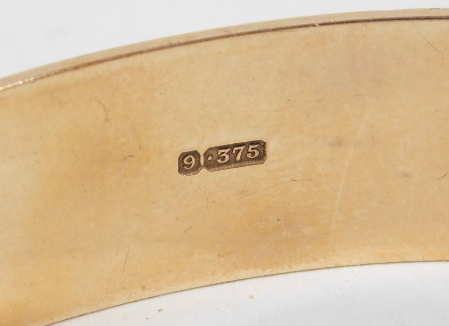 A 9ct gold bangle, with engraved repeating acanthus leaf decoration, on a snap clasp, 24.5g. - Image 2 of 3