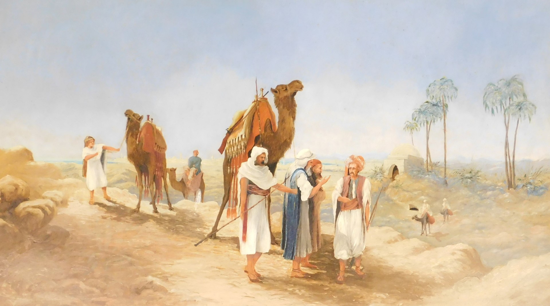 British School (20thC). A desert scene with bedouins, camels, palm trees and a city in the distance,