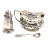 An Edward VII silver mustard pot, with blue glass liner, and embossed foliate scroll decoration, Bir