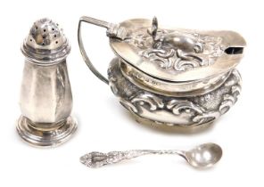 An Edward VII silver mustard pot, with blue glass liner, and embossed foliate scroll decoration, Bir