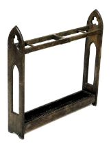 A Victorian Gothic umbrella stand, with three divisions, pierced end supports and metal drip tray, 7