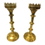 A pair of Victorian Gothic brass pricket altar candlesticks, with embossed and engraved decoration,