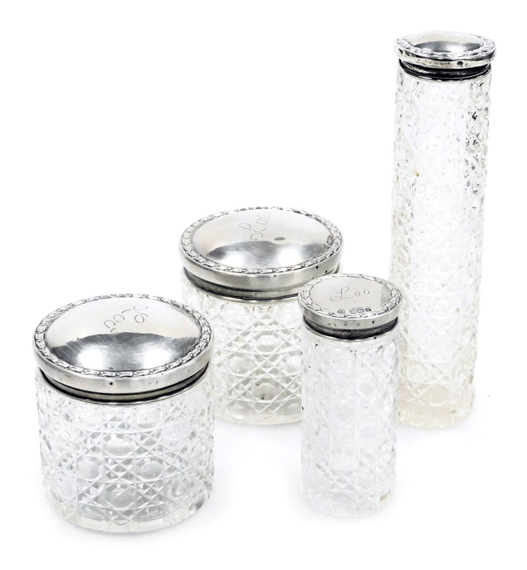 Four Edward VII cut glass and silver lidded dressing table jars, engraved Lou, Birmingham 1908 and C