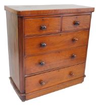 A Victorian mahogany chest of drawers, the top with rounded corners, above two short and three long