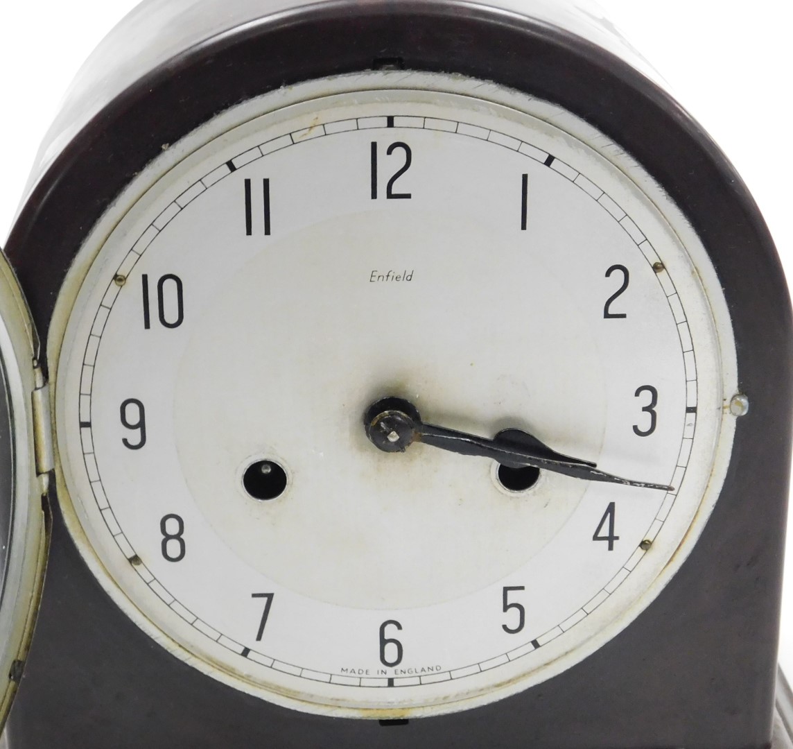 An early 20thC Enfield brown bakelite cased mantel clock, circular silver dial bearing Arabic numera - Image 4 of 5