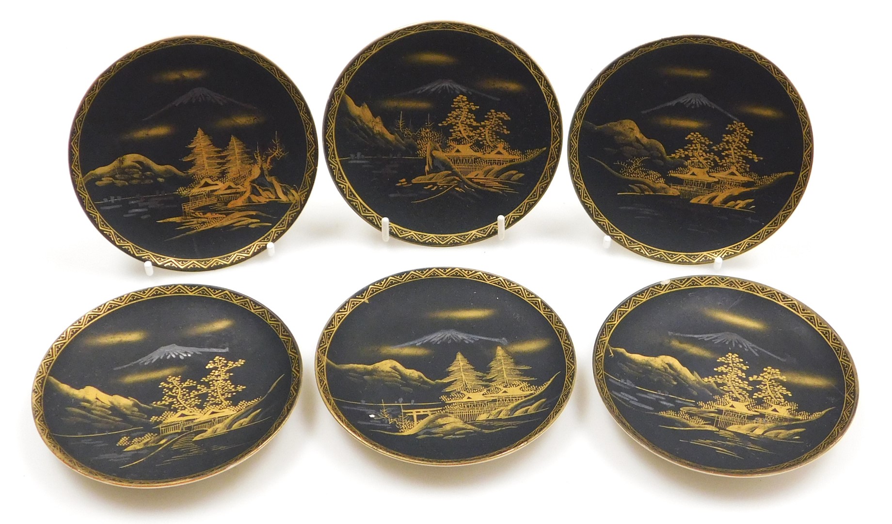 A Meiji period Japanese earthenware coffee service, gilt decorated with a river landscape before Mou - Image 2 of 16