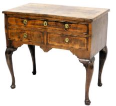 A walnut and feather banded lowboy, the rectangular quarter veneered top with a cross banded border