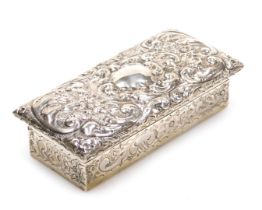 An Edward VII silver dressing table box, with embossed floral and foliate scroll decoration, vacant
