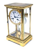 A late 19thC French brass four glass mantel clock, circular enamel dial bearing Roman numerals, eigh