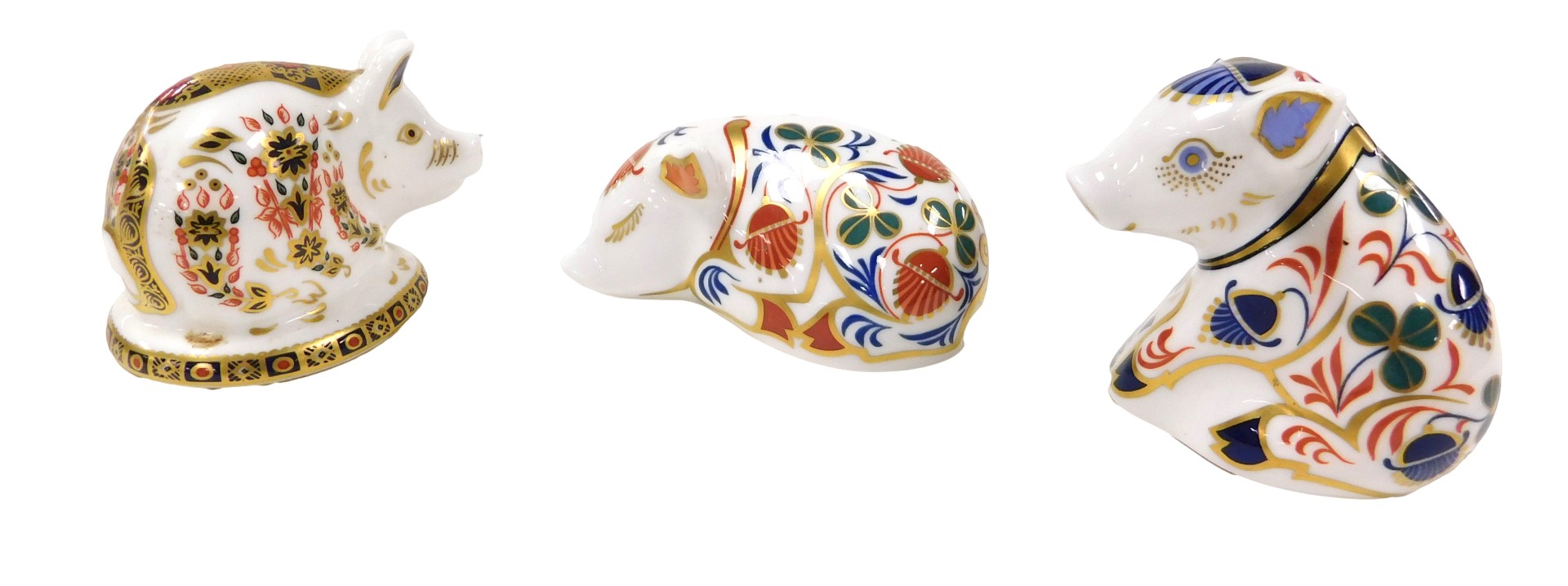 A Royal Crown Derby Imari paperweight, modelled as a sleeping pig, gold stopper, together with two f