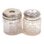 A Victorian cut glass and silver lidded dressing table jar, with embossed foliate decoration, centra