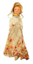 An early 20thC rag doll peg bag in original costume, with bonnet and apron, 53cm high.