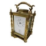 A late Victorian brass cased alarm carriage clock, rectangular white enamel dial bearing Roman numer