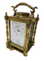 A late Victorian brass cased alarm carriage clock, rectangular white enamel dial bearing Roman numer