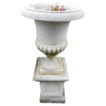 A stone campana urn with part reeded body, and square base, 117cm high.