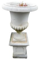 A stone campana urn with part reeded body, and square base, 117cm high.