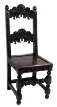 A 19thC oak Derbyshire chair, with floral and foliate carved crest rail and back, solid seat, raised