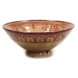 An early 20thC Hispano-Moresque copper lustre bowl, decorated with floral and foliate motifs, signed