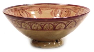 An early 20thC Hispano-Moresque copper lustre bowl, decorated with floral and foliate motifs, signed