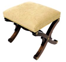 A mahogany stool, in 19thC style, with a gold coloured padded seat and X shaped end supports with gi