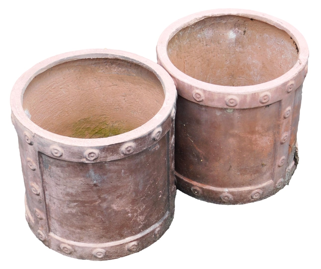 A pair of terracotta coloured cylindrical garden planters, of industrial form with stylised rivets,