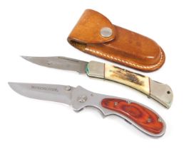 A Winchester folding pocket knife, together with a silver moose pocket knife by Burton McCall, with
