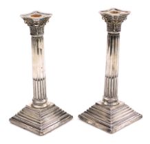 A pair of George V loaded silver Corinthian column candlesticks, Birmingham 1911, 34.53oz all in, 24