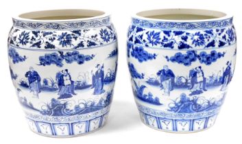 A pair of Chinese blue and white jardineres, each decorated with figures within leaf and flower bord