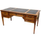 A French style cherrywood desk, the rectangular top with three black and gilt inserts above an arran