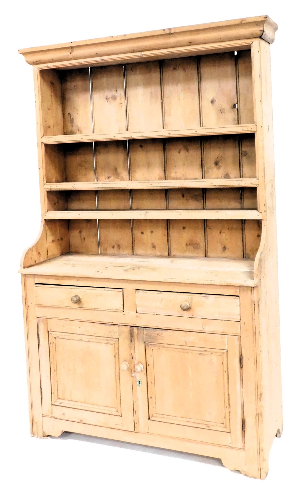 A Victorian stripped pine dresser, with moulded cornice, plate rack top, two drawer and two door cu