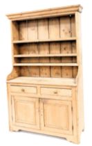 A Victorian stripped pine dresser, with moulded cornice, plate rack top, two drawer and two door cu