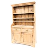 A Victorian stripped pine dresser, with moulded cornice, plate rack top, two drawer and two door cu