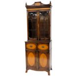 A mahogany and satinwood secretaire bookcase in George III style, the top with a shaped cornice and