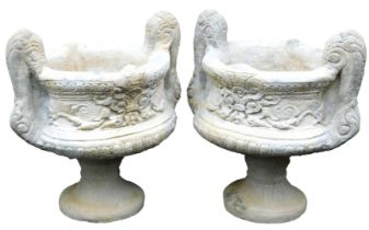 A pair of concrete garden urns, with double scroll handles, 47cm wide.