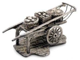 An Elizabeth II silver model of a handcart, with a box of apple, sack of potatoes, and basket of cau