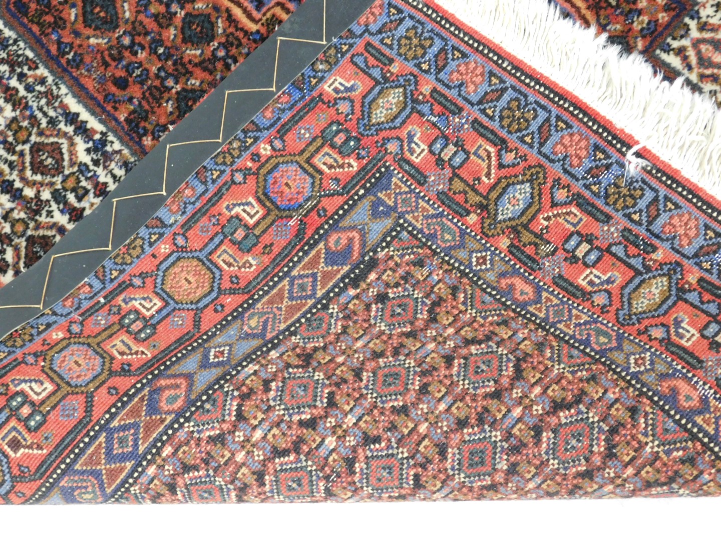 A Persian rug, with all over decoration of geometric devices, one wide and two narrow borders, 153cm - Image 3 of 3