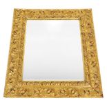 A gilt wall mirror, with moulded decoration of leaves, etc., surrounding a bevelled plate, 87cm high