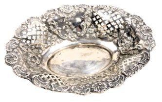 A Victorian silver oval sweet meat dish, of pierced and embossed form, decorated with flowers and sc