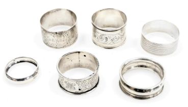 Six silver napkin rings, variously decorated, 3.55oz.