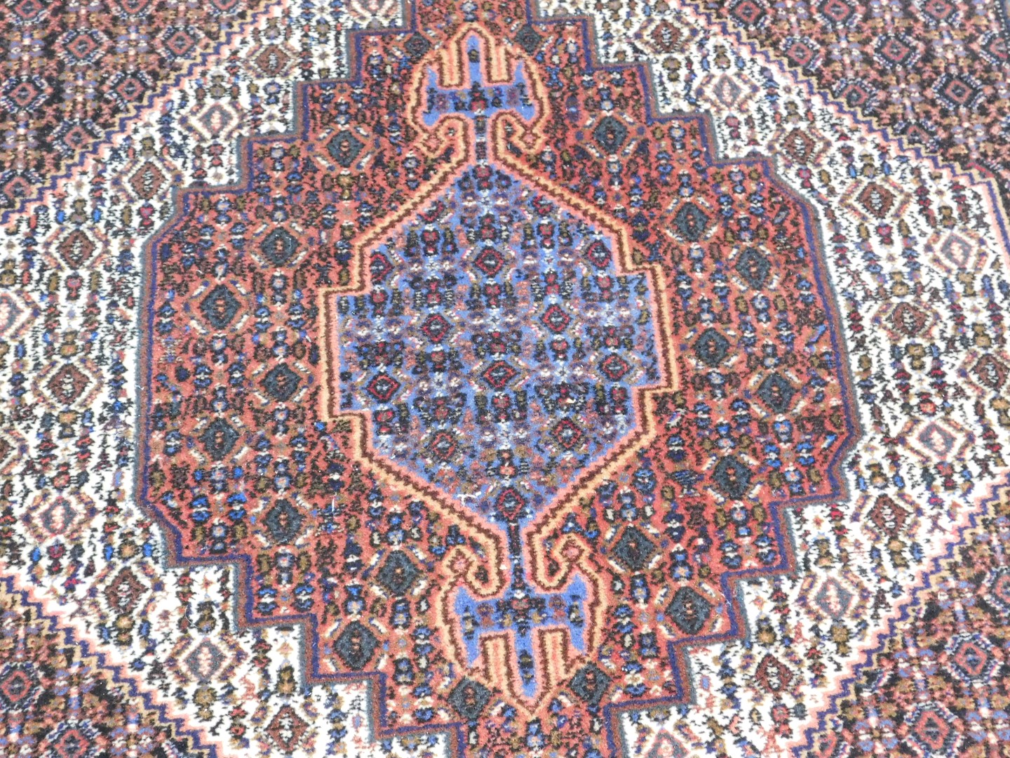 A Persian rug, with all over decoration of geometric devices, one wide and two narrow borders, 153cm - Image 2 of 3